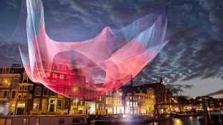 Illustration for article titled Artists creates awesome artificial glowing nebulae over city skies